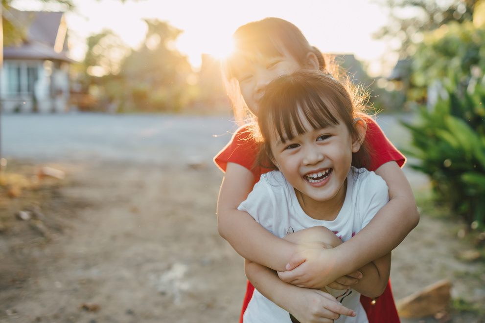 Happy Kids Hugging Outdoors 